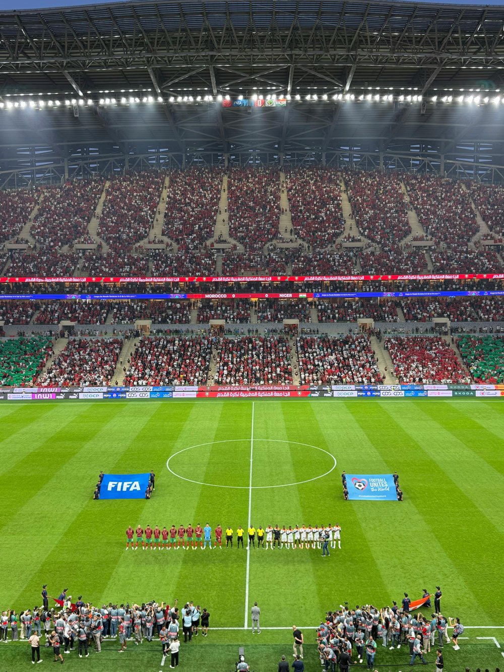 Dramatic stadium at night with crowd and lights